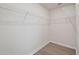 Spacious walk-in closet featuring white wire shelving and wood-look flooring at 2885 Deer Pine Trl, Land O Lakes, FL 34638