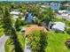 Scenic aerial view of a waterfront home nestled among lush greenery, showcasing canal access and a peaceful residential neighborhood at 301 Carlyle Blvd, Ruskin, FL 33570