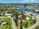 Aerial view highlighting a waterfront property with canal access, surrounded by mature trees and a charming residential neighborhood at 301 Carlyle Blvd, Ruskin, FL 33570