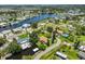 Picturesque aerial view of a waterfront neighborhood featuring lush landscaping, canal access, and charming homes, ideal for serene living at 301 Carlyle Blvd, Ruskin, FL 33570