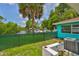 Charming backyard with lush lawn, canal view, and boat dock, perfect for waterfront living and enjoying Florida's outdoors at 301 Carlyle Blvd, Ruskin, FL 33570