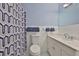Bathroom featuring blue patterned shower curtain, and white cabinets at 301 Carlyle Blvd, Ruskin, FL 33570