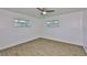 Spacious bedroom featuring wood-look floors, and two windows at 301 Carlyle Blvd, Ruskin, FL 33570