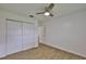 Bedroom includes a closet, wood-look floors and ceiling fan at 301 Carlyle Blvd, Ruskin, FL 33570
