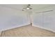 Wood-look flooring in this bedroom with closet and ceiling fan at 301 Carlyle Blvd, Ruskin, FL 33570