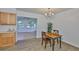 Dining area features wood-look flooring and leads to the bright living area at 301 Carlyle Blvd, Ruskin, FL 33570
