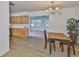 Dining area with wood-look flooring adjacent to the modern kitchen at 301 Carlyle Blvd, Ruskin, FL 33570