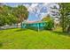 Charming turquoise home with a well-maintained lawn, mature trees, and a fenced yard, creating a welcoming curb appeal at 301 Carlyle Blvd, Ruskin, FL 33570