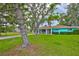 Charming one-story home featuring a covered carport, screened-in porch, and lush landscaping at 301 Carlyle Blvd, Ruskin, FL 33570