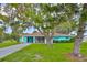 Charming one-story home featuring a covered carport and a screened-in porch at 301 Carlyle Blvd, Ruskin, FL 33570