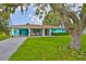 Charming one-story home featuring a covered carport and a screened-in porch at 301 Carlyle Blvd, Ruskin, FL 33570