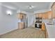 Updated kitchen with stainless steel appliances and stylish wood-look flooring at 301 Carlyle Blvd, Ruskin, FL 33570