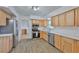 Updated kitchen with stainless steel appliances, light wood cabinets and wood-look flooring at 301 Carlyle Blvd, Ruskin, FL 33570