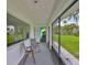 Screened porch with seating area, natural light, and access to outdoor views at 301 Carlyle Blvd, Ruskin, FL 33570