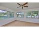 Bright sunroom with tiled floor, ceiling fan, and views of the canal at 301 Carlyle Blvd, Ruskin, FL 33570