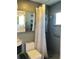 Modern bathroom showcasing gray tile, a sleek sink, and a shower stall with chevron curtain at 3014 58Th S St, Gulfport, FL 33707