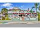 Sea Breeze Manor Inn featuring a charming green exterior with a white balcony and colorful accents under a sunny sky at 3014 58Th S St, Gulfport, FL 33707
