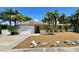 Charming single-story home with tropical landscaping, a driveway, and a one-car garage at 3014 58Th S St, Gulfport, FL 33707