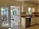 Cozy kitchen with stainless steel dishwasher and sink, leading to a screened-in lanai at 3014 58Th S St, Gulfport, FL 33707