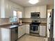 Functional kitchen with stainless steel appliances and white cabinets, ready for culinary adventures at 3014 58Th S St, Gulfport, FL 33707