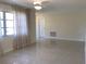 Bright living room with polished terrazzo floors and sheer curtains, enhancing natural light at 3014 58Th S St, Gulfport, FL 33707