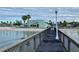 Scenic waterfront view from the pier with clear water, a sandy beach, and a view of Gulfport in the distance at 3014 58Th S St, Gulfport, FL 33707