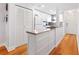 A pristine kitchen featuring white cabinets, stainless steel appliances, and hardwood floors at 3018 59Th S St # 405, Gulfport, FL 33707
