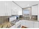 Well-appointed kitchen featuring stainless appliances, designer backsplash, and ample counter space at 3018 59Th S St # 405, Gulfport, FL 33707