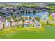 Aerial view of homes surrounding a lake with lush landscaping and swimming pools at 31244 Baclan Dr, Wesley Chapel, FL 33545