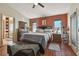 Spacious bedroom featuring a ceiling fan, wood floors, and an ensuite bathroom at 31244 Baclan Dr, Wesley Chapel, FL 33545