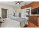 Bedroom with a ceiling fan, laminate flooring, lots of natural light, and modern decor at 31244 Baclan Dr, Wesley Chapel, FL 33545