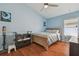 Cozy bedroom features wood floors, blue walls, and lots of natural light from window at 31244 Baclan Dr, Wesley Chapel, FL 33545