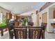 Dining room with cherry wood table and a view of the modern kitchen at 31244 Baclan Dr, Wesley Chapel, FL 33545