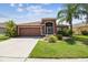 Charming single-story home featuring a well-maintained lawn and an attached two-car garage at 31244 Baclan Dr, Wesley Chapel, FL 33545