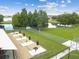 Community grilling area with multiple grills and picnic tables, perfect for outdoor cooking and dining near the pond at 31244 Baclan Dr, Wesley Chapel, FL 33545