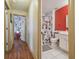 Hallway view leads to a shared bedroom with whimsical decor and a Mickey Mouse-themed bathroom at 31244 Baclan Dr, Wesley Chapel, FL 33545
