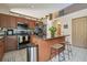 Kitchen features a center island with breakfast bar, stainless appliances, and tile flooring at 31244 Baclan Dr, Wesley Chapel, FL 33545