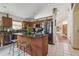 Open kitchen features an island, stainless appliances, and breakfast bar seating at 31244 Baclan Dr, Wesley Chapel, FL 33545