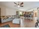 Open-concept living area with hardwood floors seamlessly connecting the kitchen and dining spaces at 31244 Baclan Dr, Wesley Chapel, FL 33545