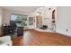 Open-concept living room featuring hardwood floors, a wine rack, and natural light at 31244 Baclan Dr, Wesley Chapel, FL 33545