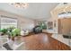 Spacious living room with hardwood floors, large windows, and modern light fixture at 31244 Baclan Dr, Wesley Chapel, FL 33545
