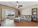 Comfortable living room with a plush sofa, hardwood floors, and a view of the screened lanai at 31244 Baclan Dr, Wesley Chapel, FL 33545