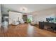 Bright living room featuring hardwood floors, comfortable seating, and a view of the outdoor space at 31244 Baclan Dr, Wesley Chapel, FL 33545