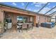 Lovely covered patio with brick flooring, seating, and outdoor kitchen perfect for entertaining and relaxation at 31244 Baclan Dr, Wesley Chapel, FL 33545