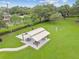 Aerial view of a covered picnic area with tables and grills in a grassy park setting at 31244 Baclan Dr, Wesley Chapel, FL 33545