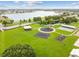 Aerial view of a community playground, park, and lake, offering recreational amenities at 31244 Baclan Dr, Wesley Chapel, FL 33545
