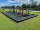 Outdoor fitness area in a community park setting features various exercise structures at 31244 Baclan Dr, Wesley Chapel, FL 33545