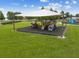 Shaded playground area with climbing structures, slides, and ample space for children to play and explore at 31244 Baclan Dr, Wesley Chapel, FL 33545