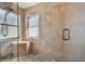Modern tiled shower with a bench, a handheld shower head and a river rock floor at 31244 Baclan Dr, Wesley Chapel, FL 33545