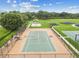 Community tennis court with benches and well-maintained surroundings for sports and recreational activities at 31244 Baclan Dr, Wesley Chapel, FL 33545